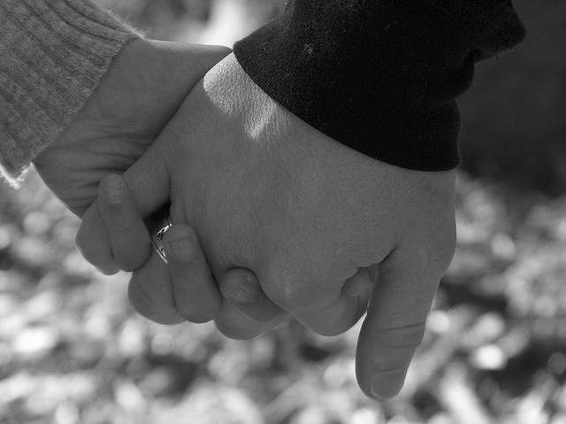 people holding hands in black and white