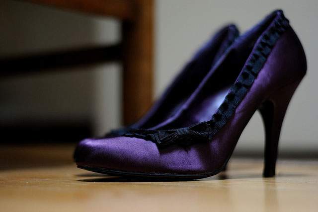 purple heel shoes on a wood floor