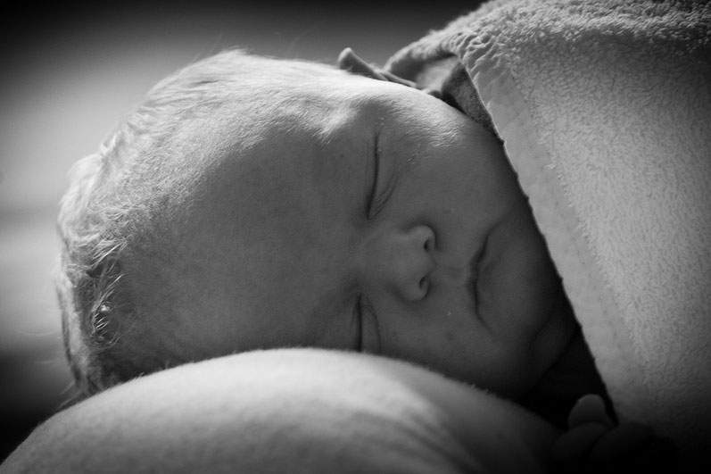 newborn baby sleeping in black and white photo