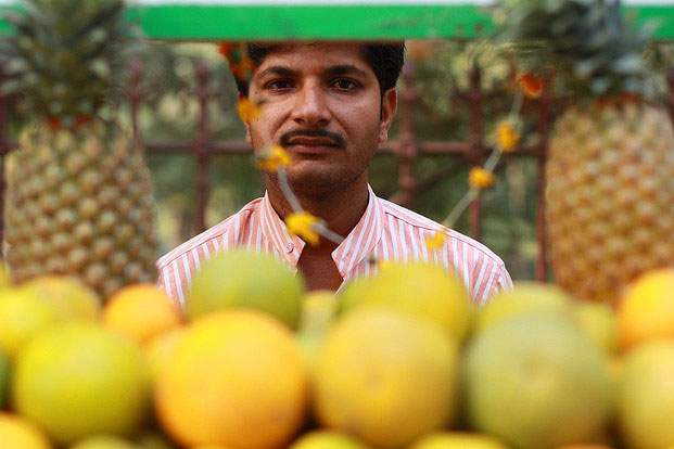 man standing in front of fruit