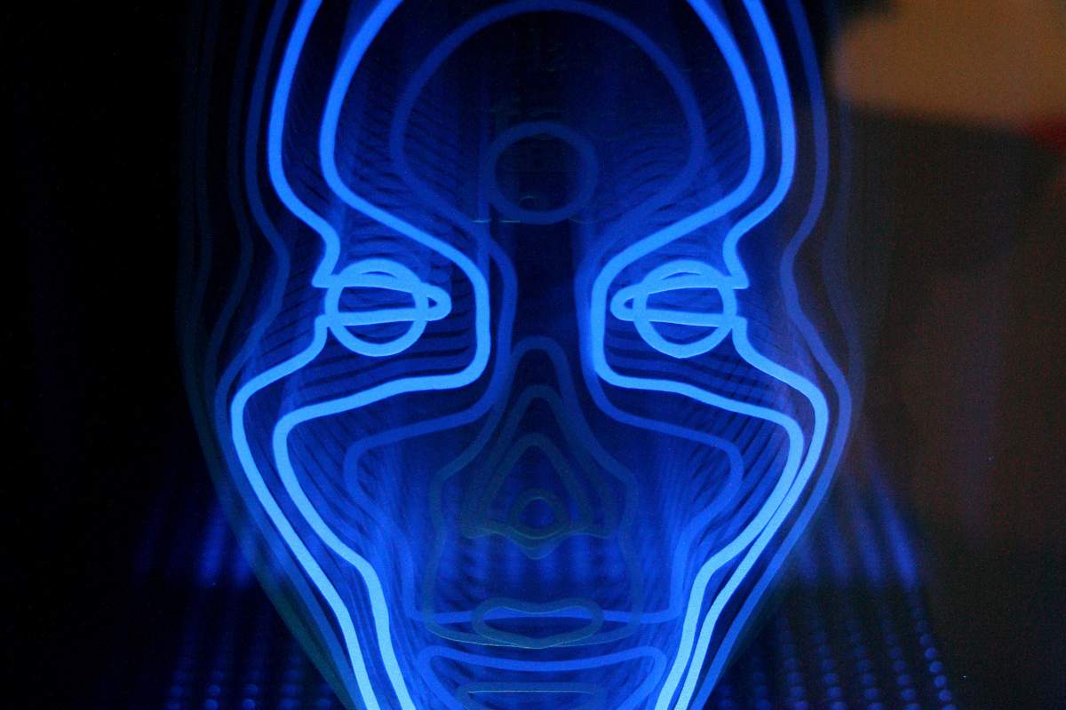 Blue fluorescent light sculpted into the shape of a human face