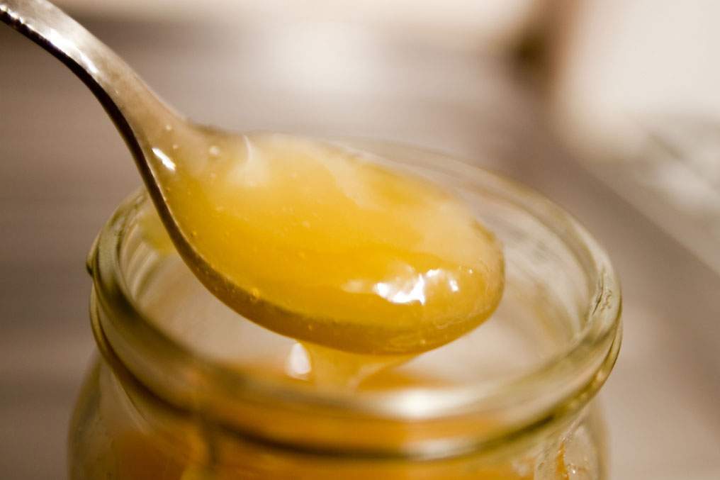 Honey spooned out of a jar.