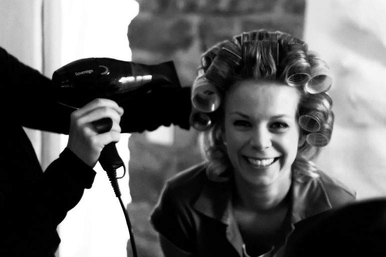 A hair stylist works to achieve a perfect head of curls.