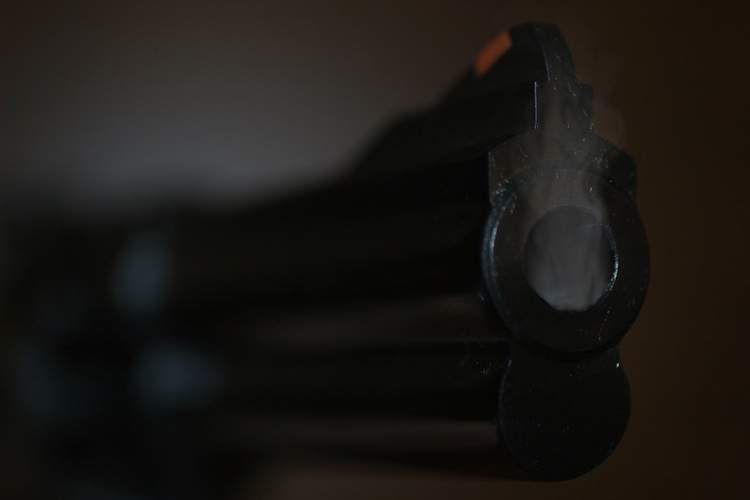 Close-up of a smoking gun barrel