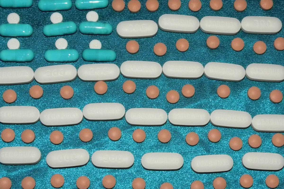 Assorted pills arranged on a blue cloth