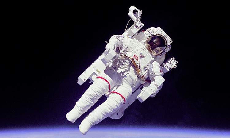 An astronaut floats in a space suit.