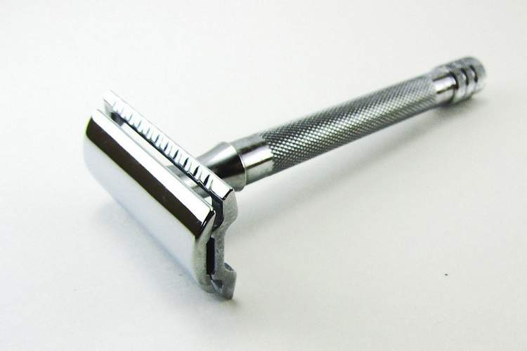 A safety razor against a white background