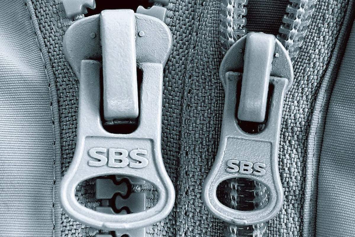 Close-up of two zipper pulls