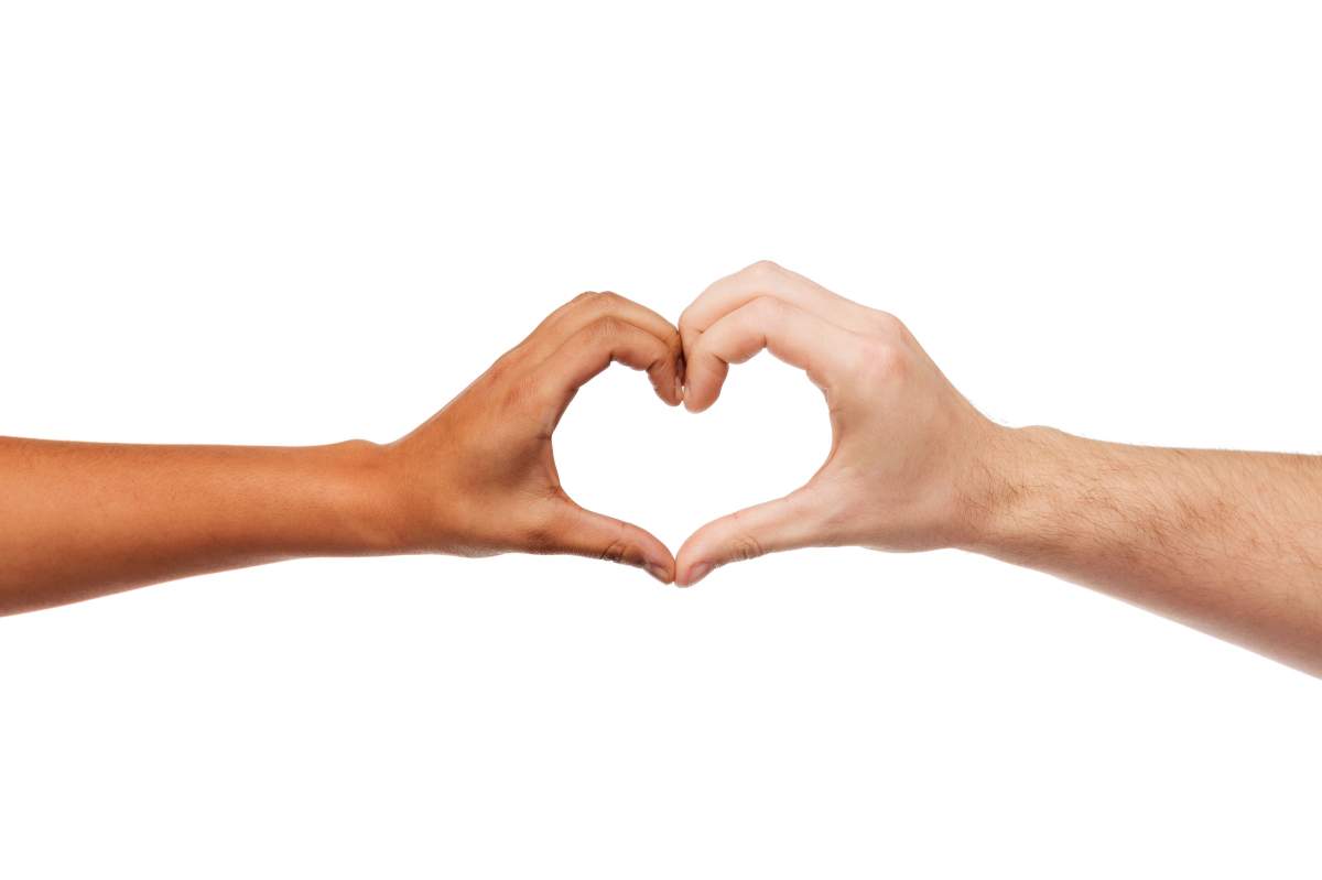 Two hands reach out toward each other to form a heart shape gesture.