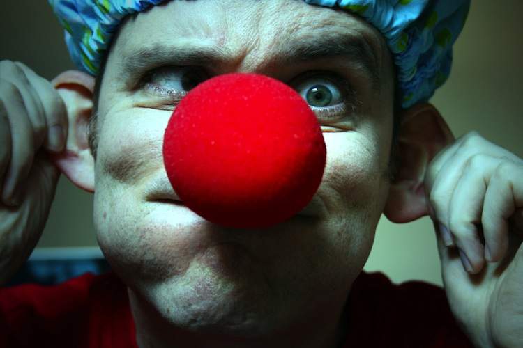 Man with red clown nose making a funny face