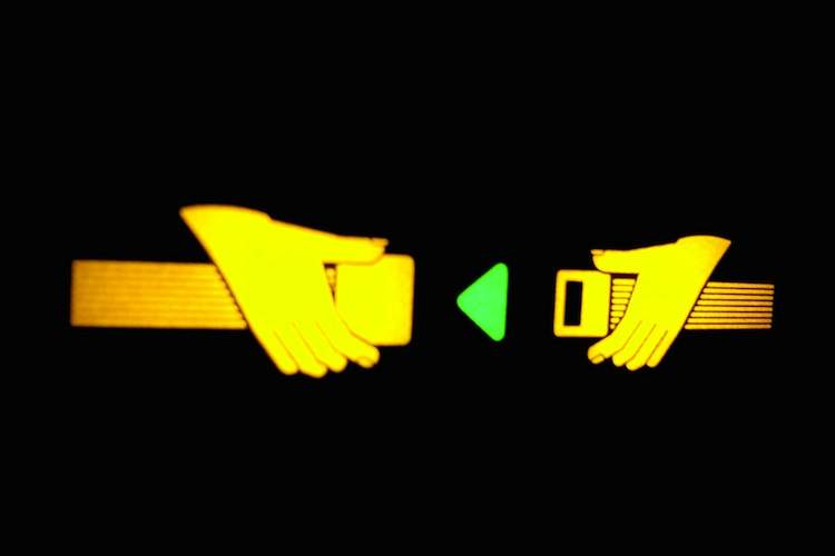 A yellow "fasten seatbelt" sign