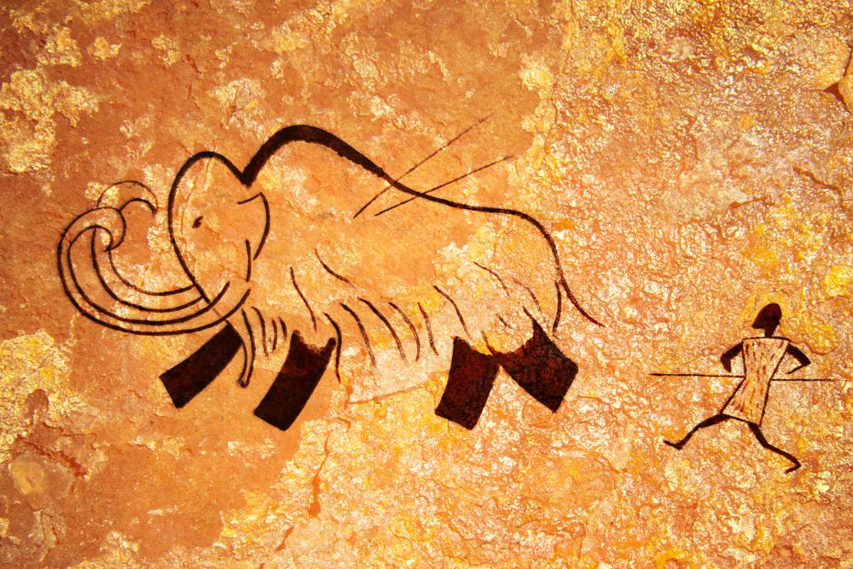 Cave painting of a hunter spearing a wooly mammoth