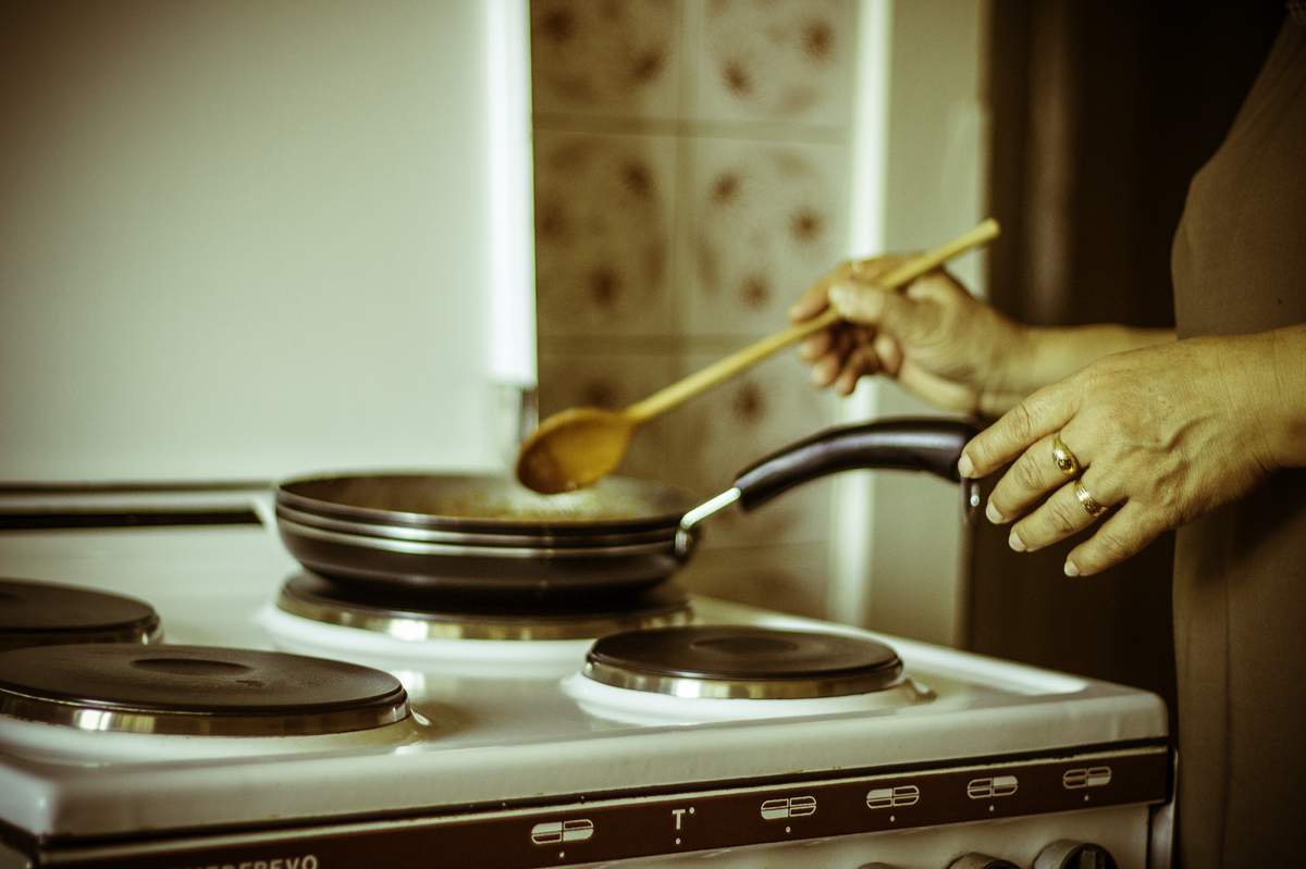 woman cooks at stovetop