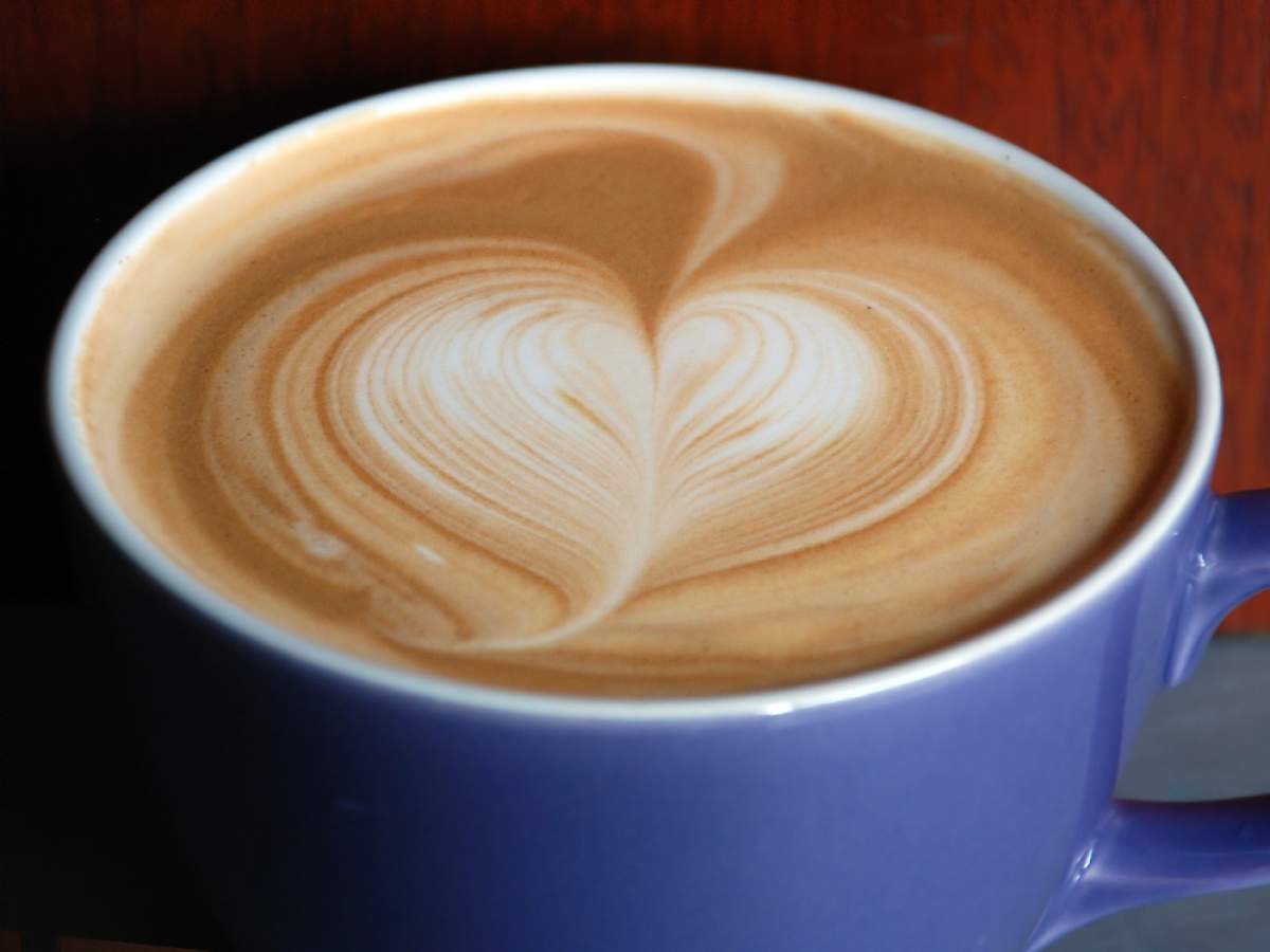 A cup of coffee with a heart drawn in the foam.
