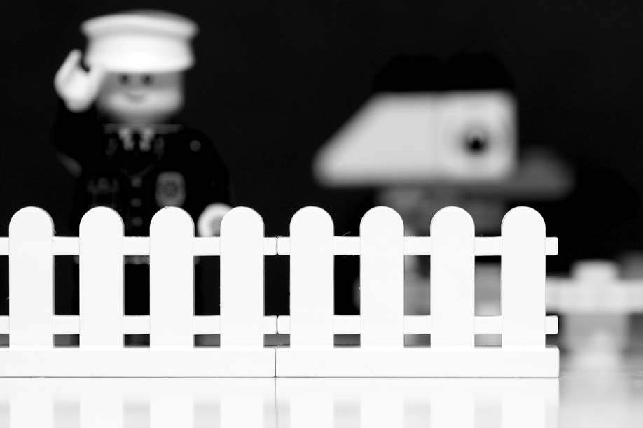 lego scene with white picket fence