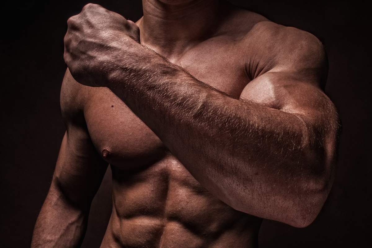 muscle man flexes forearm