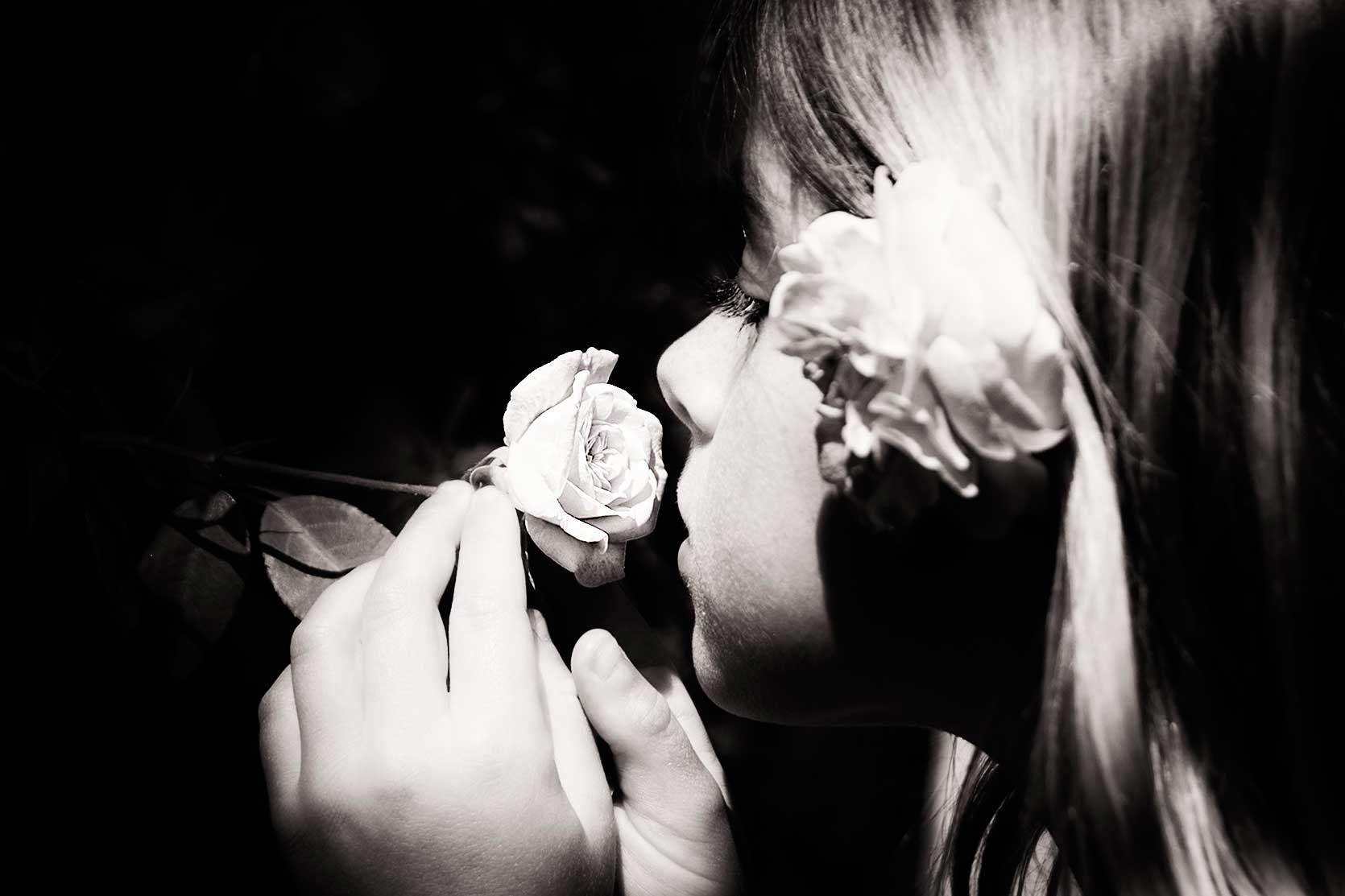 girl smelling a rose
