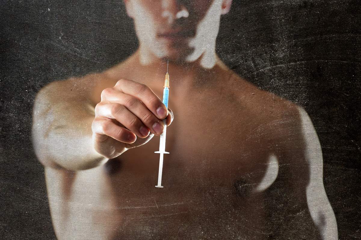 muscle man holding syringe