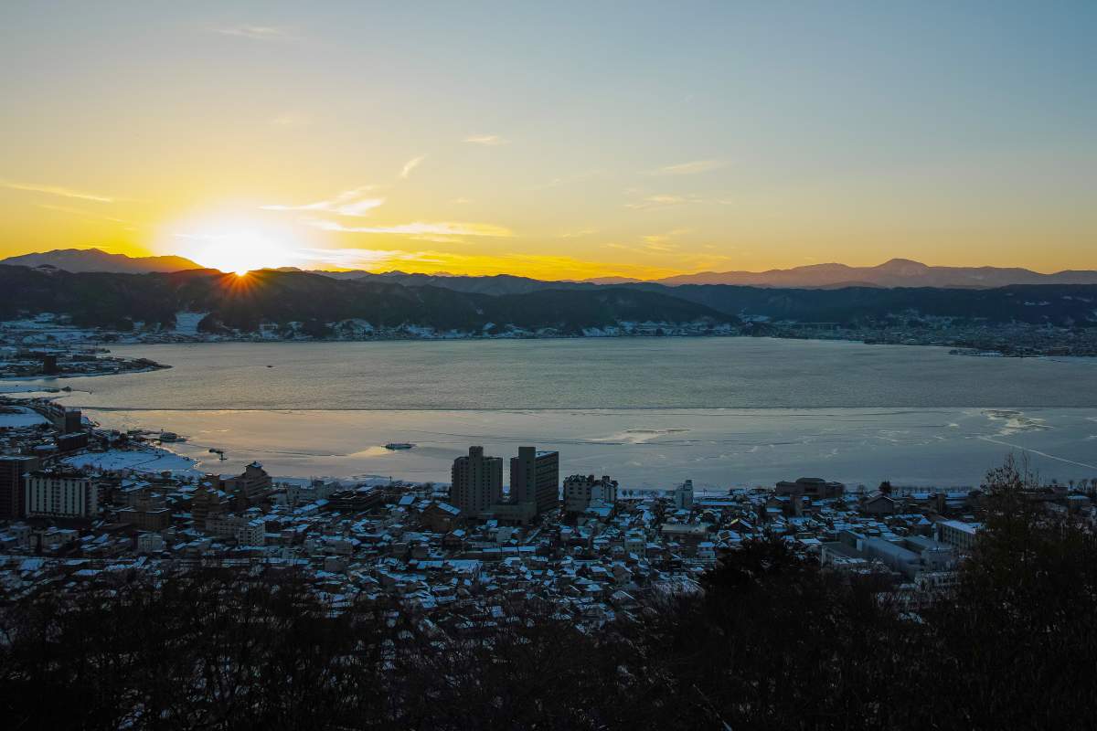 A sunset over Lake Suwa in the winter