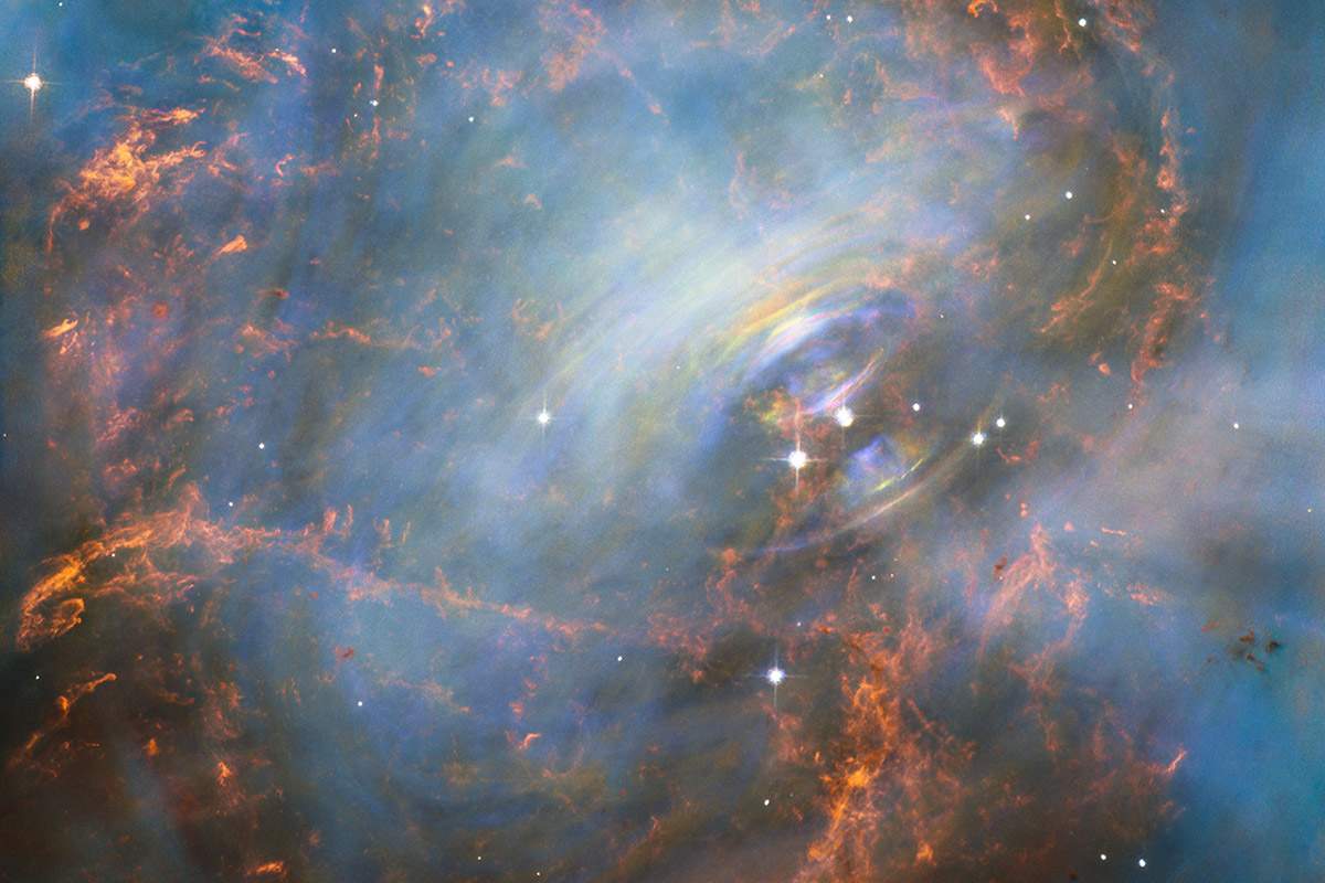 A color image of the Crab Nebula. This nebula is home to the star that scientists monitored to discover pulsars.