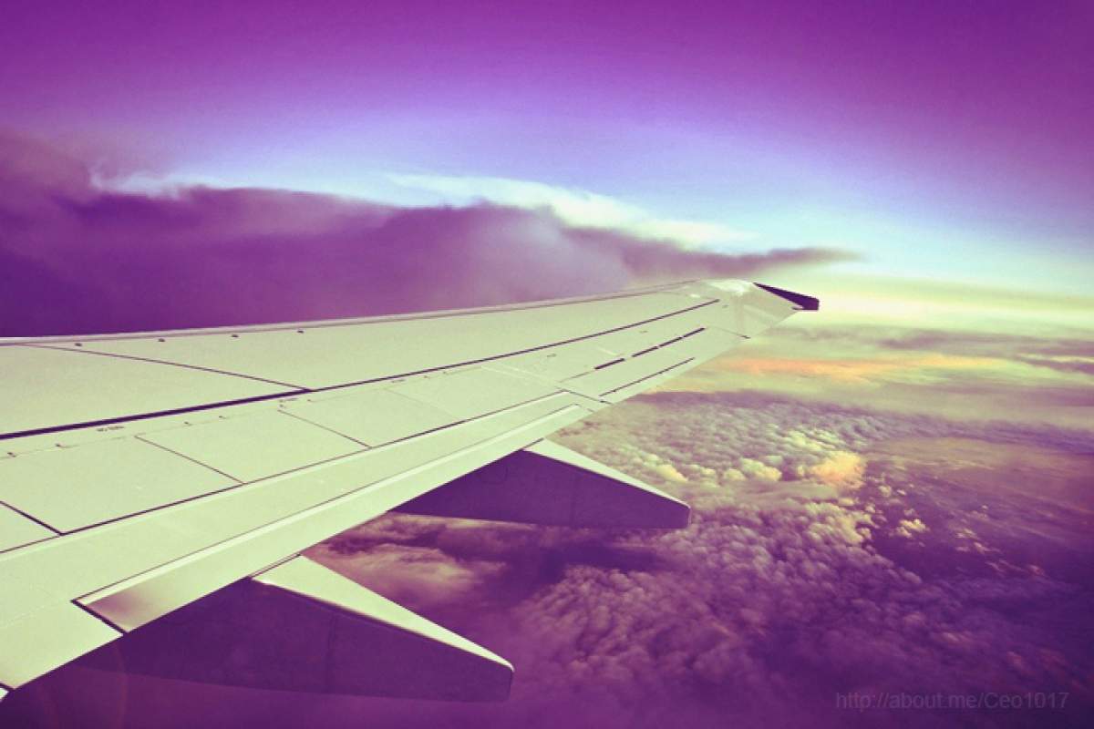airplane wing, cloudy skies
