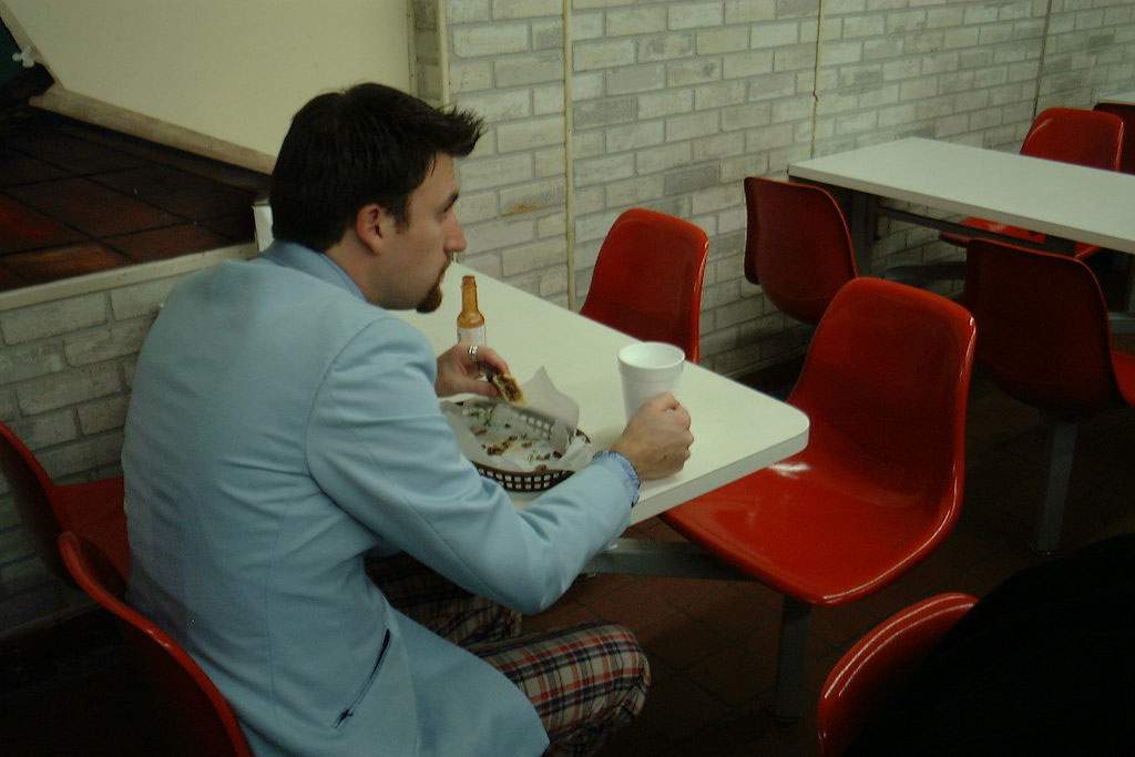 a man eating tacos alone