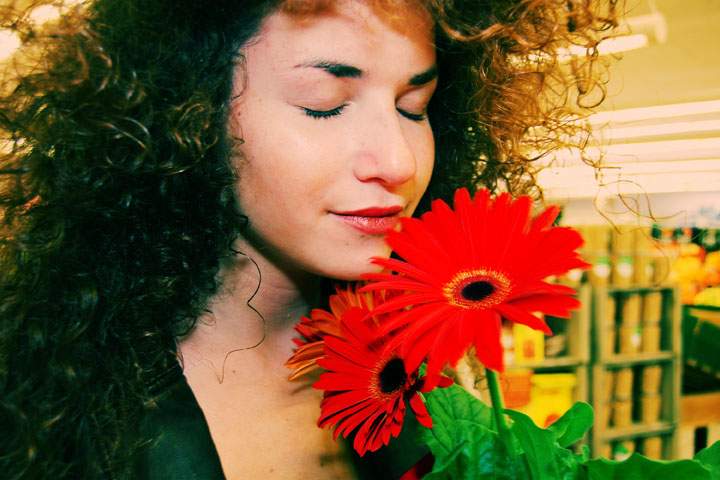 a woman smelling flowers