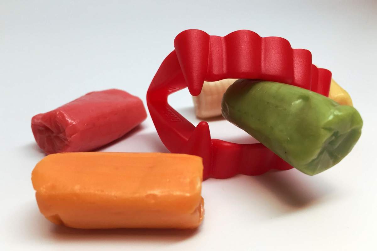 Red plastic vampire teeth and some candies. (NIAID, Flickr)
