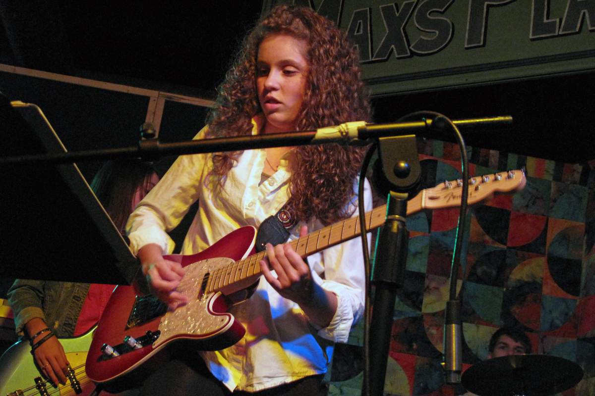 Sadie Johnson plays electric guitar