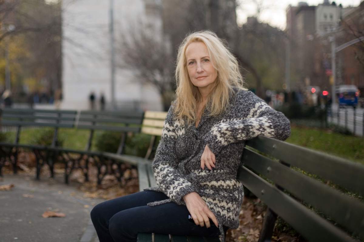 author sits on a park bench