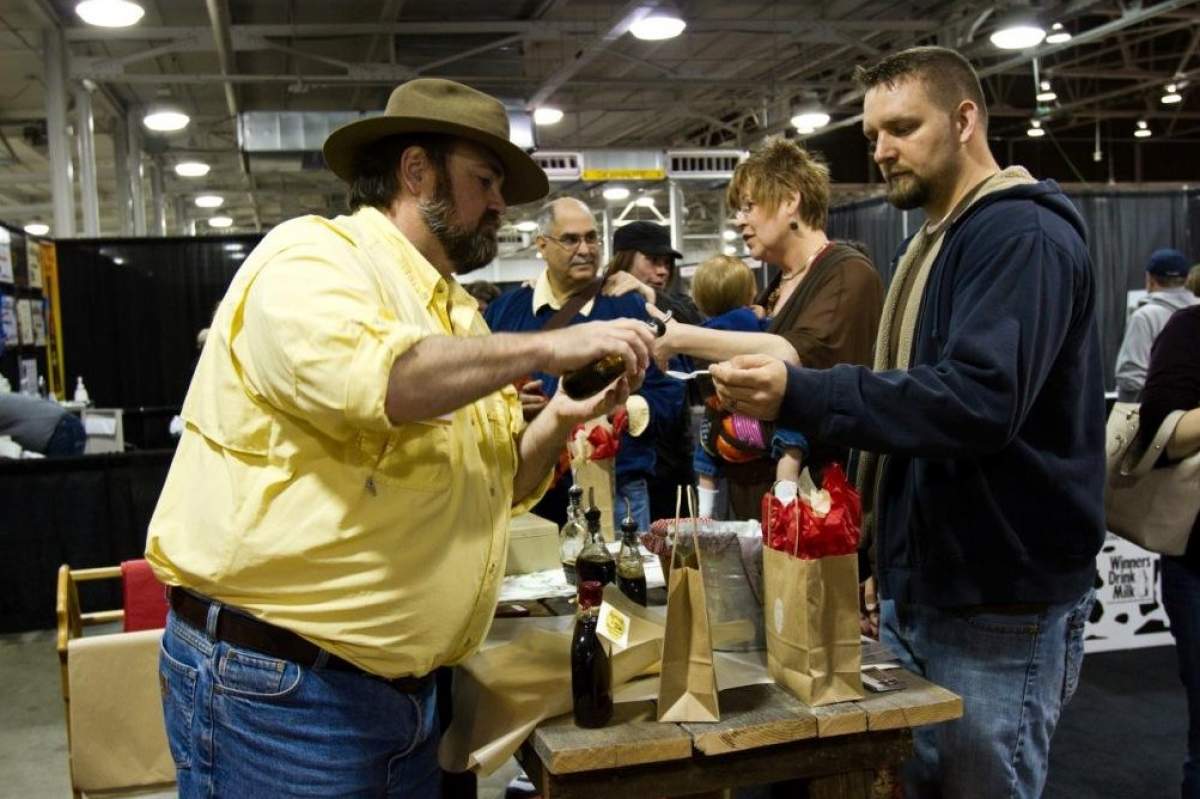 syrup maker pours a sample for a customer