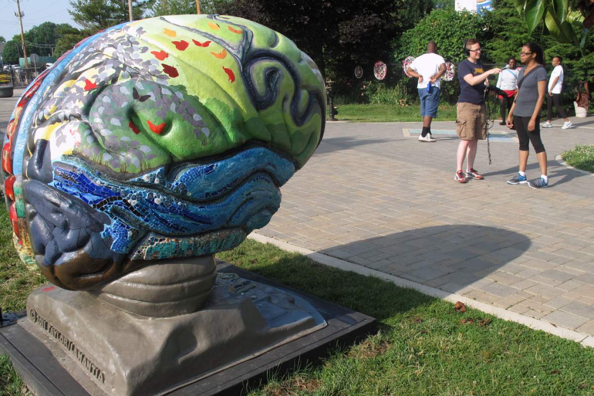 brain sculpture and passer-by