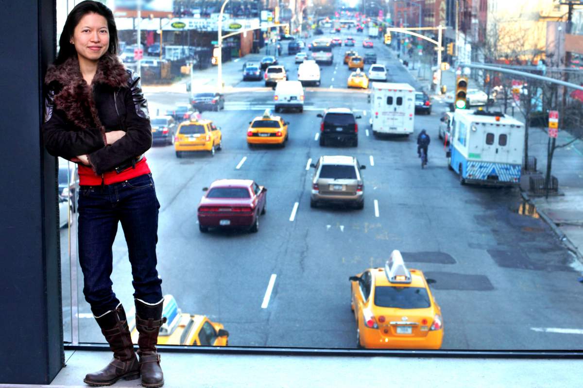 composer posing in a window overlooking NYC traffic