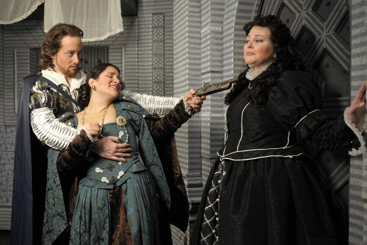 Don Giovanni grasps at pistol packing Donna Elvira as she threatens Donna Anna