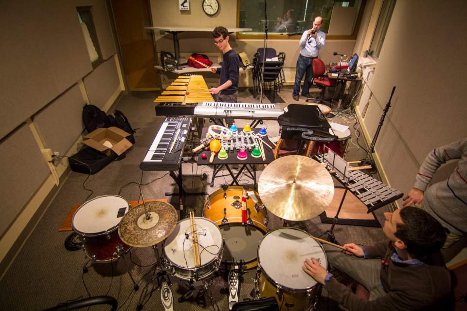 a large group of various percussion instruments fill a recording studio