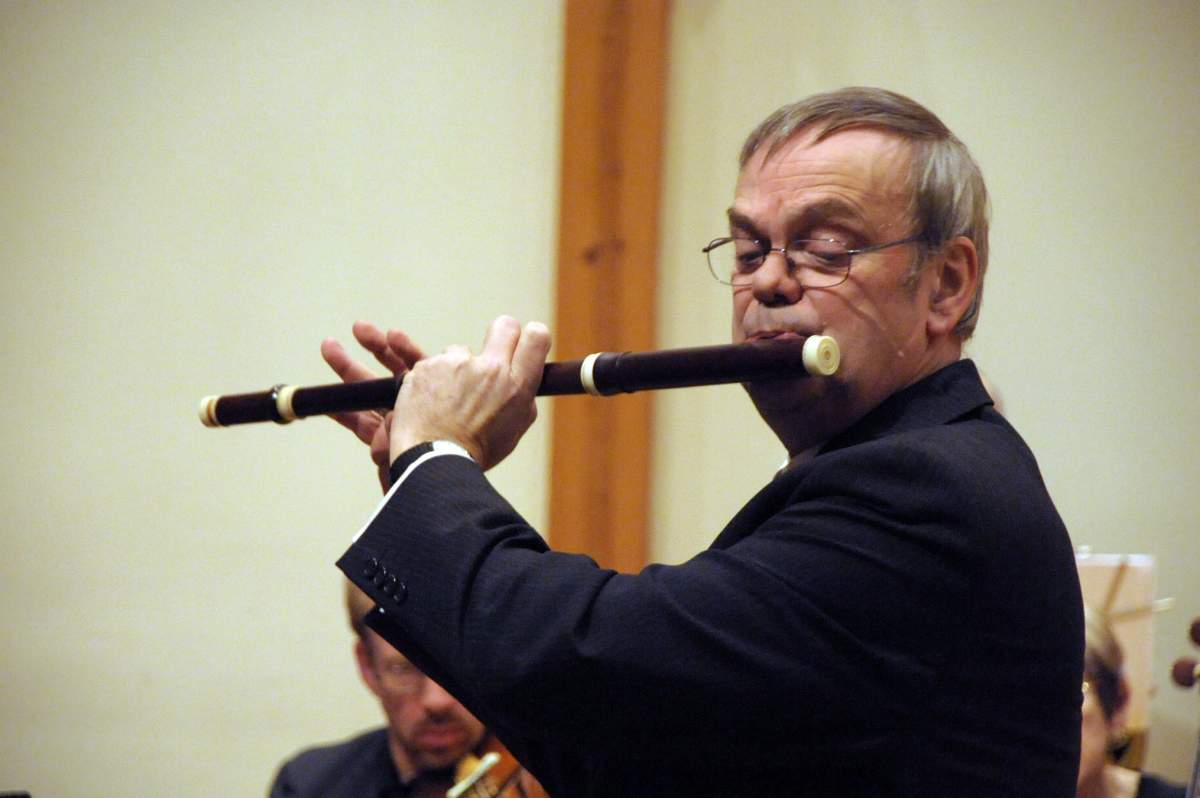 a man plays a flute