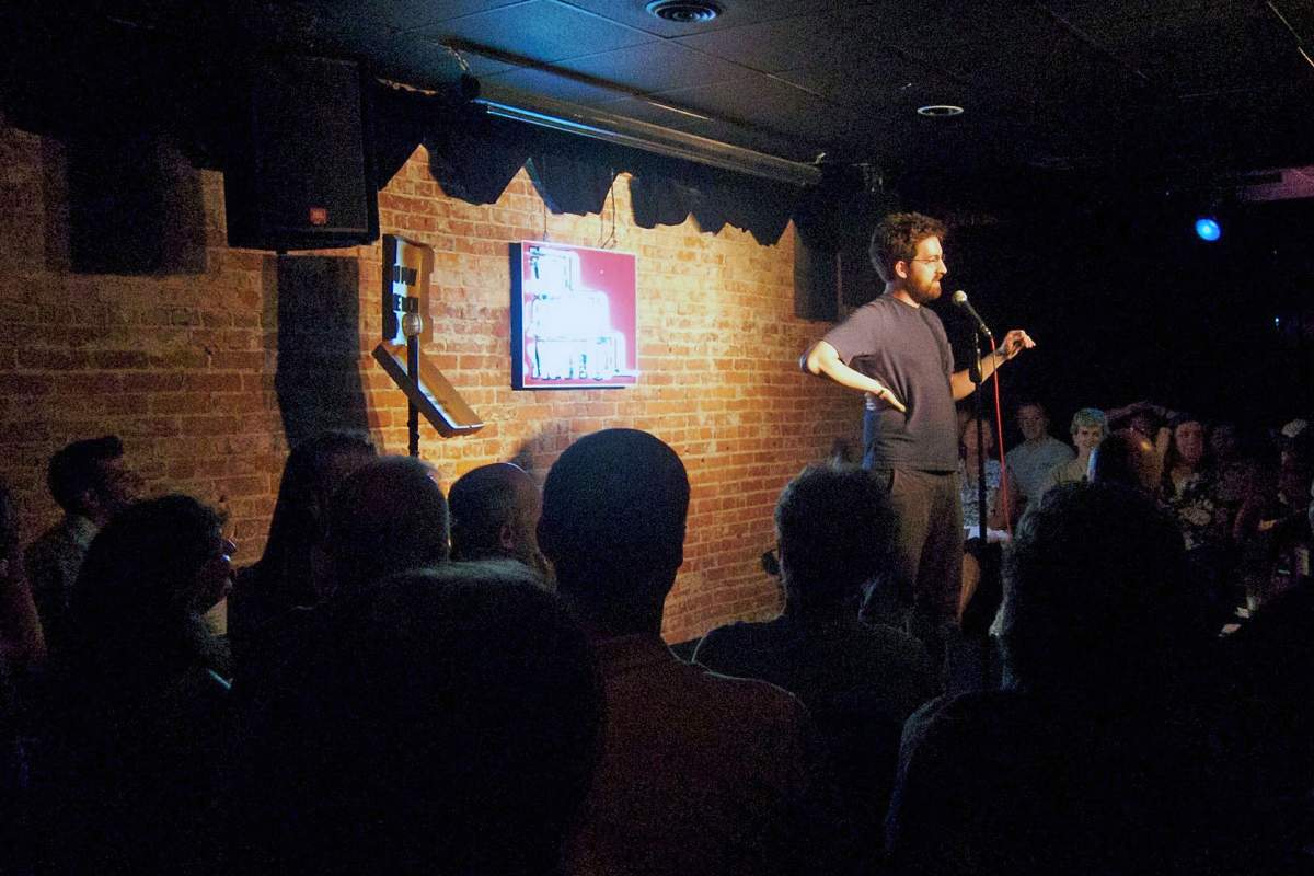 comedian on stage at comedy attic