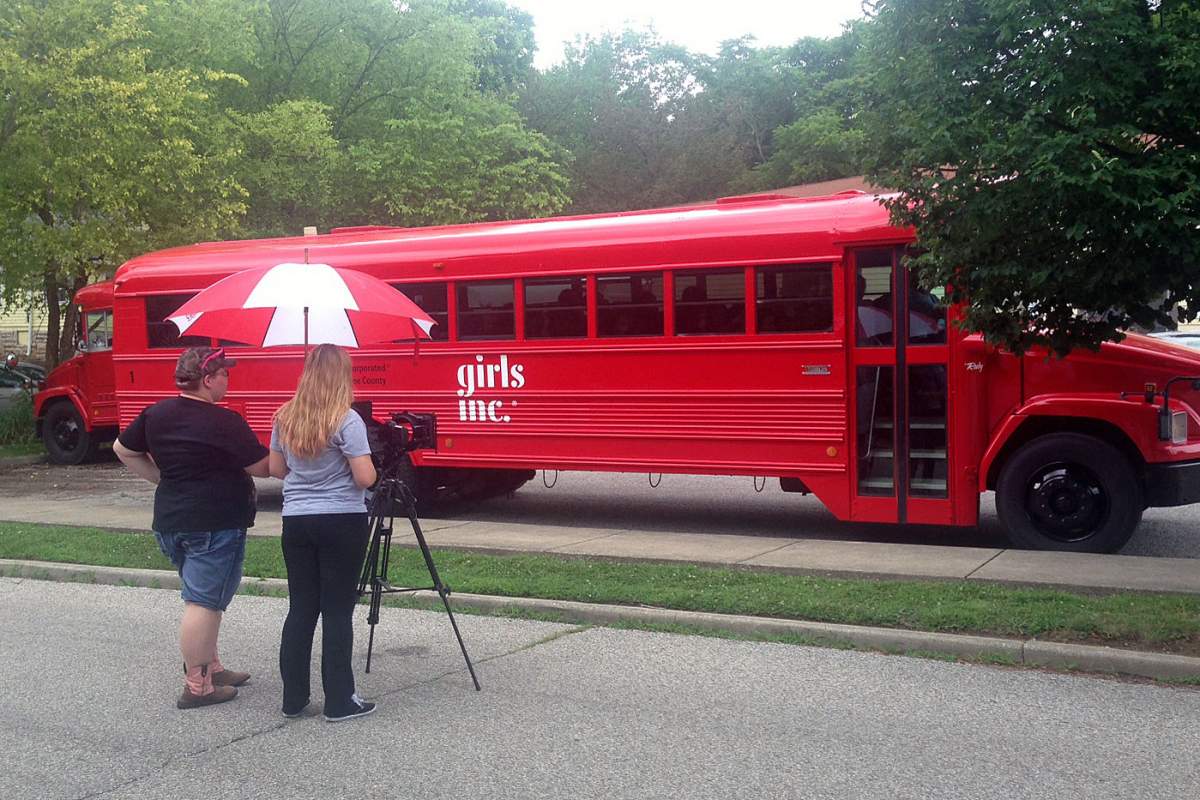 students filming Girls Inc bus