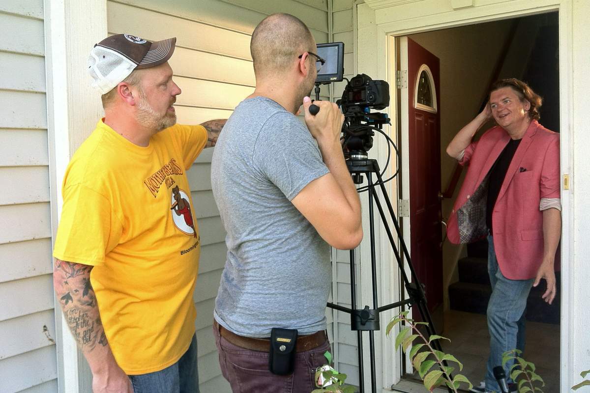 actor, director and cameraman on a front porch