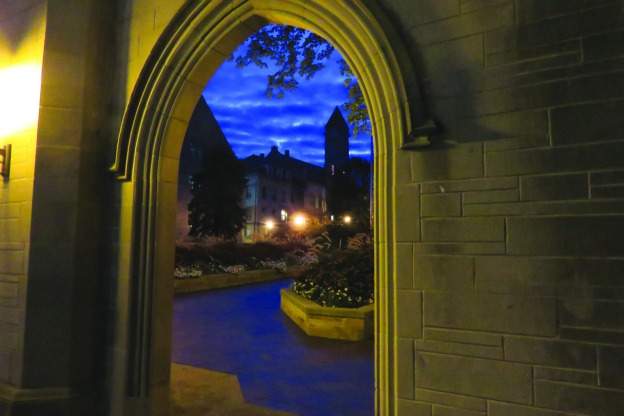 view of early morning sky through limestone arch on IU campus
