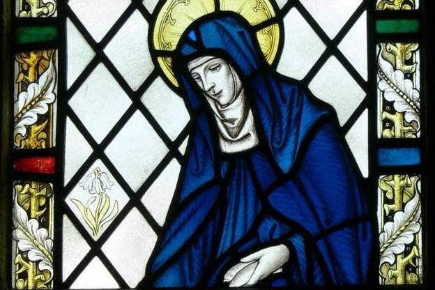 Detail of a stained glass window showing Saint Brigid of Kildare at Our Lady and Saint Non's Chapel in St Davids, Wales.