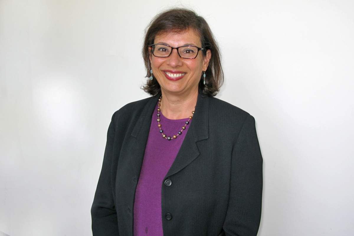 Sonia Nazario in glasses, dark brown jacket, purple top