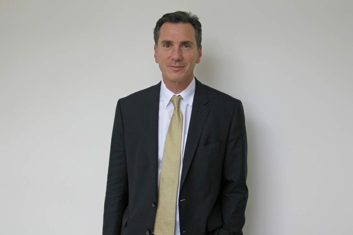 Lee A. Feinstein in black suit, gold tie