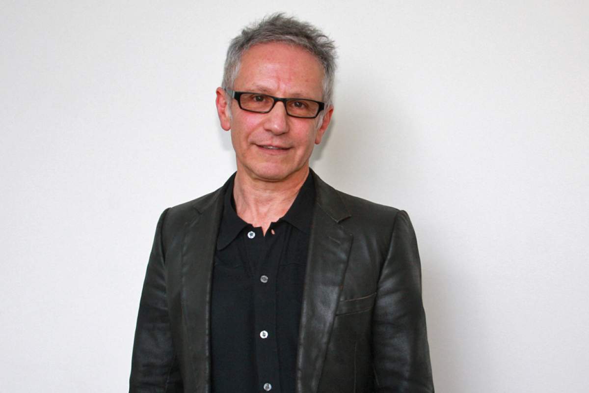 Jean-Louis Haguenauer in black shirt, horn-rimmed glasses, black leather jacket, short hair