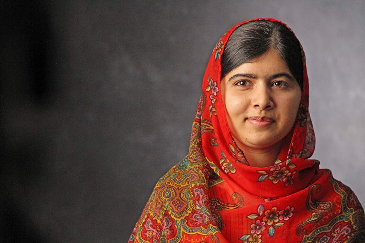 Malala Yousafzai wearing red headscarf that partially covers her hair