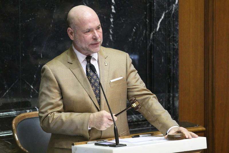 Brian Bosma in a brown suit with a gavel at a podium