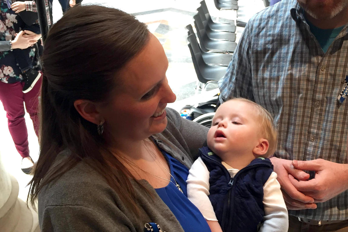 Andrea Clausen holds her son Bryce at the Statehouse.