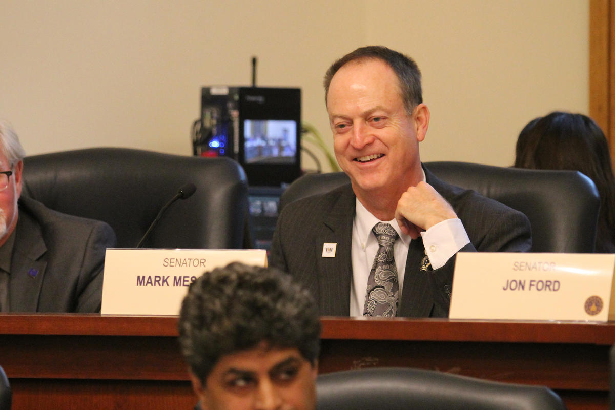 Senator Mark Messmer sits at a table in a statehouse committee room