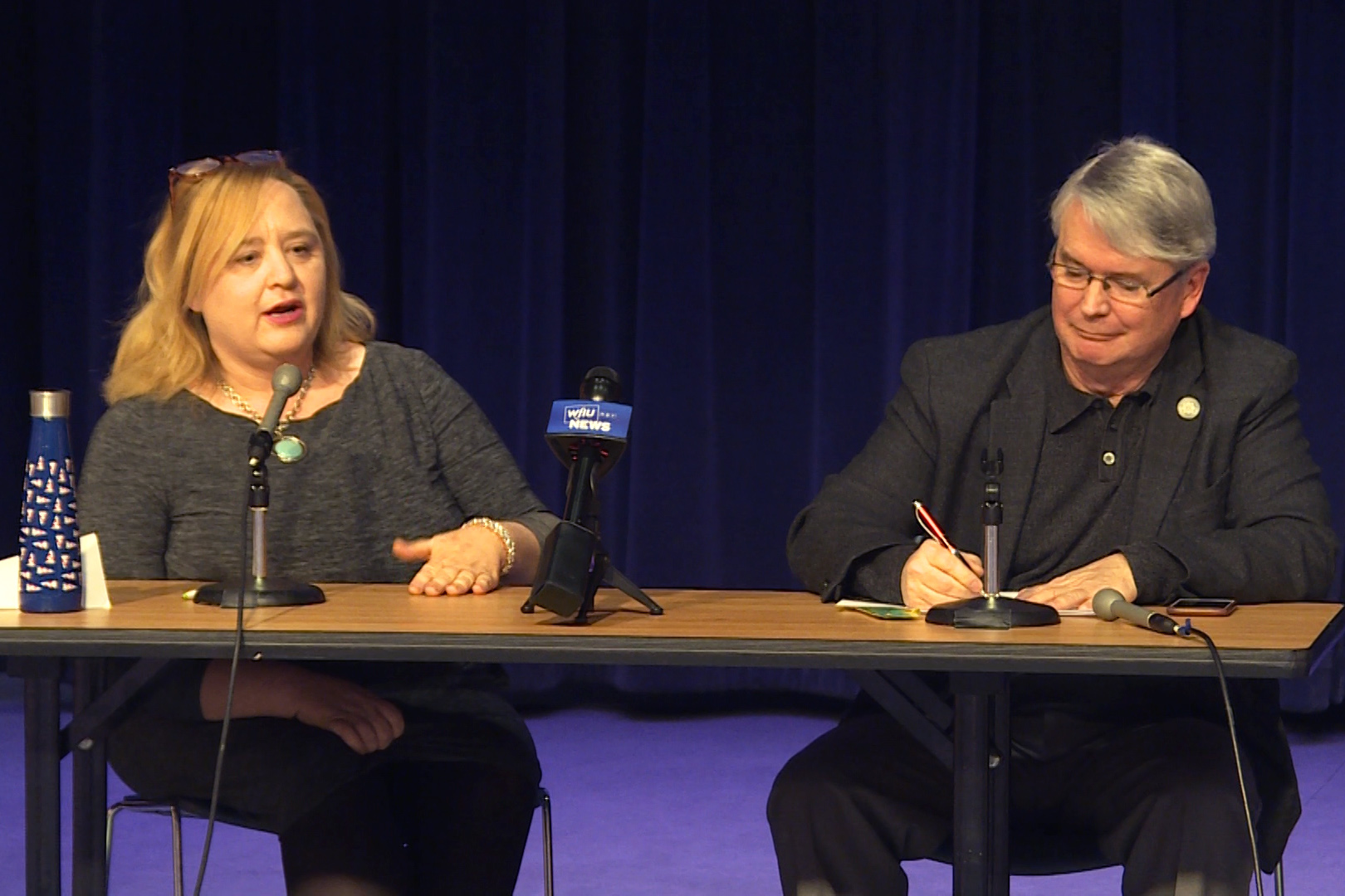 Amanda Barge and John Hamilton answering questions during a mayoral debate. 