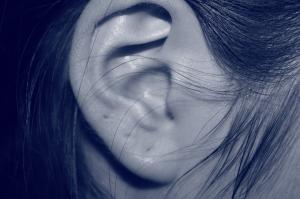 A black and white close up of a woman's ear